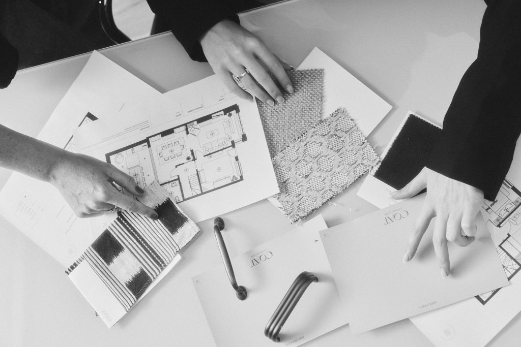 interior design Interior designers reviewing floor plans and fabric samples at Topology Interiors' London studio