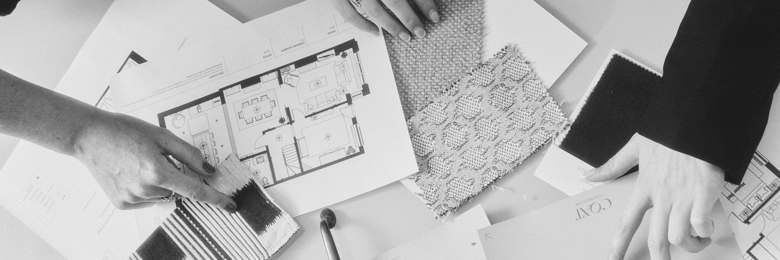 Interior designers reviewing floor plans and fabric samples, Topology Interiors London