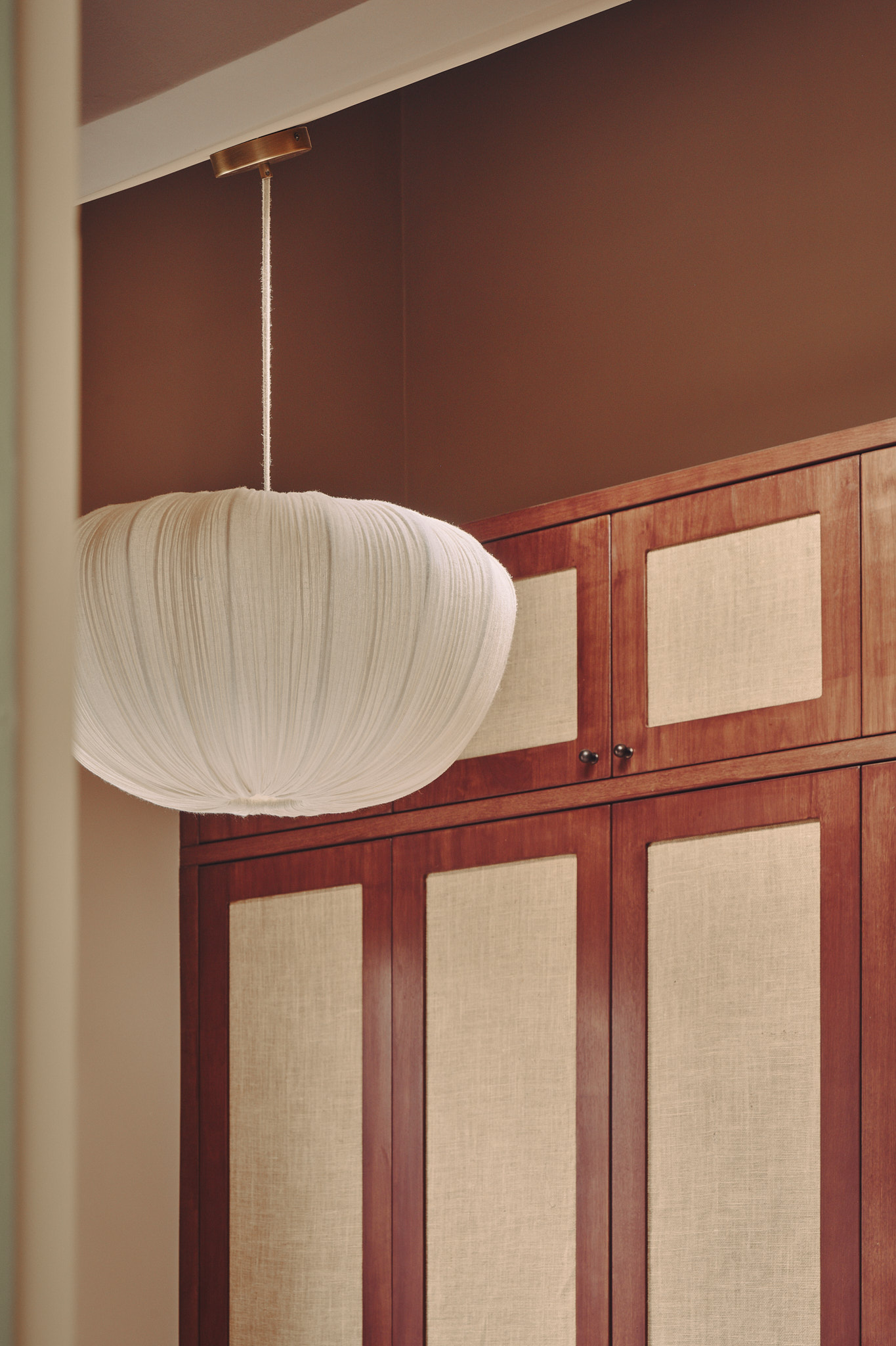 Cane-fronted wardrobes and a pleated pendant