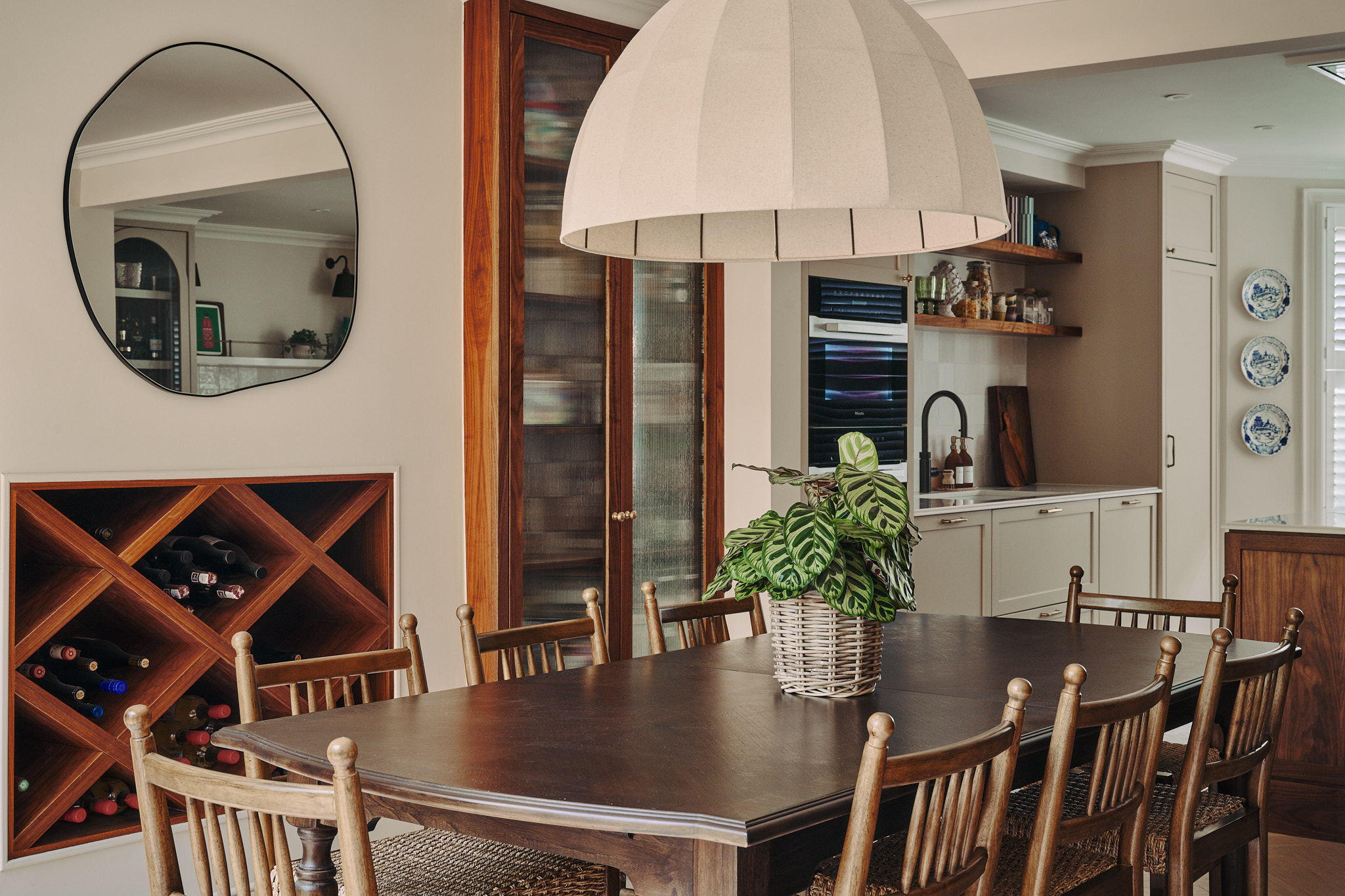 Stephanie's open-plan kitchen and dining room with walnut island and glass-door cocktail cabinet