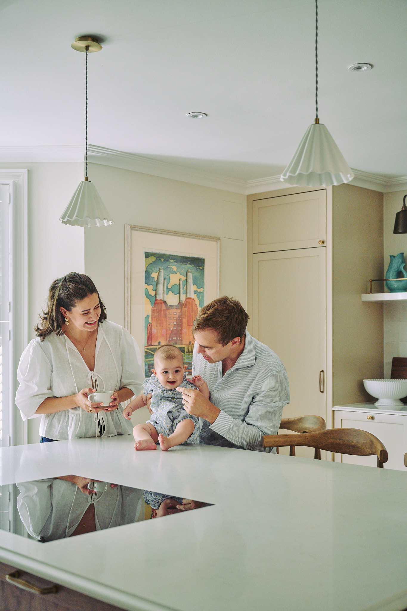 Stephanie with her partner and baby daughter at the kitchen island